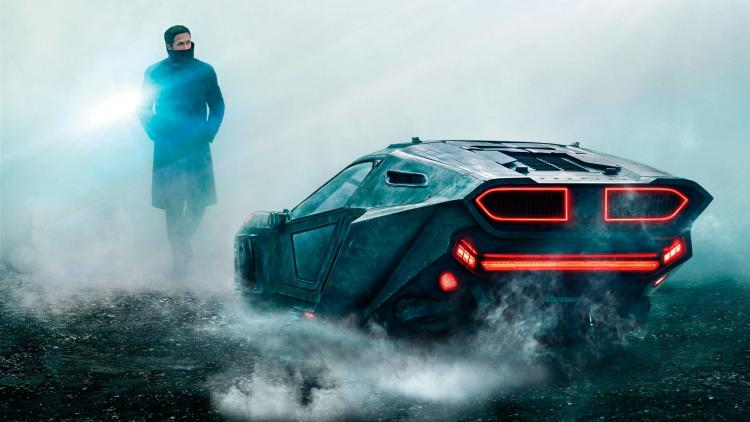 Ryan Gosling next to his brand new ride in Blade Runner 2049.